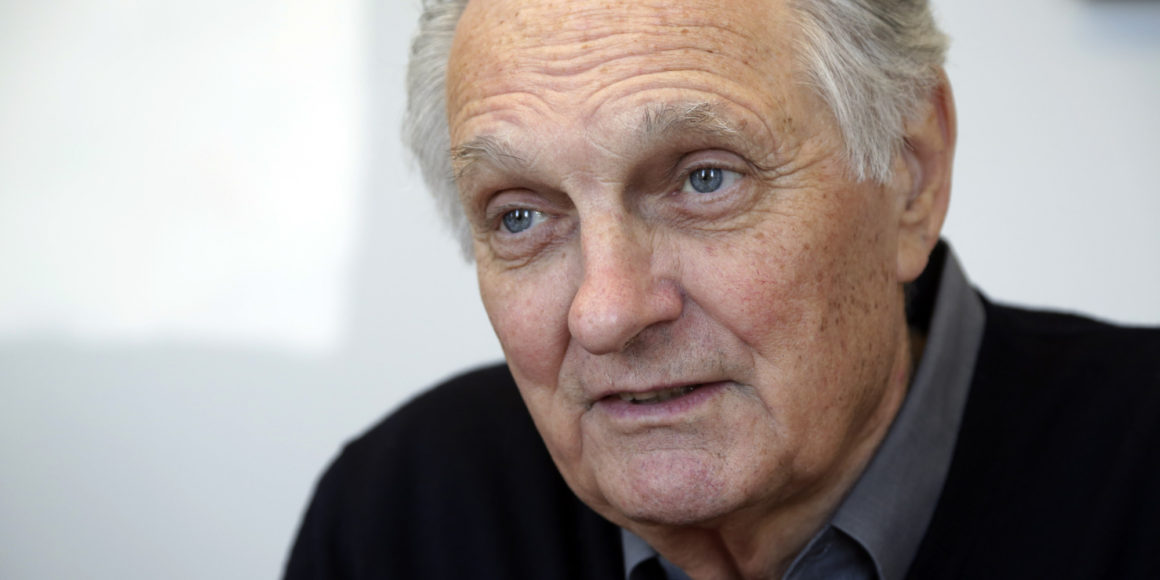 In this Friday, April 26, 2013 photo, actor Alan Alda speaks during an interview at Stony Brook University, on New York's Long Island. The film and television star is trying to encourage scientists of all disciplines to ditch the jargon and speak in plain English. (AP Photo/Richard Drew)